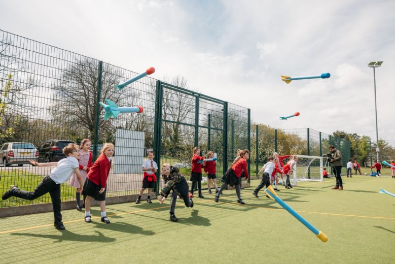 children throwing foam javelins
