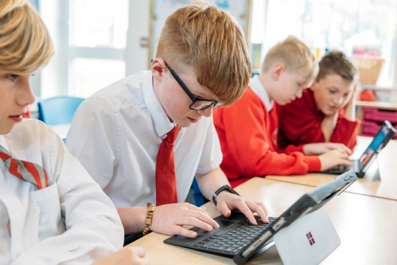 child programming a laptop