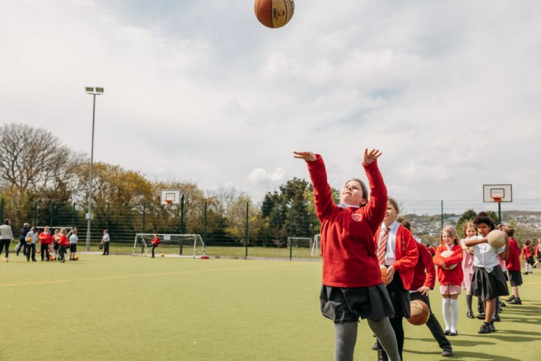 child shooting a basketball