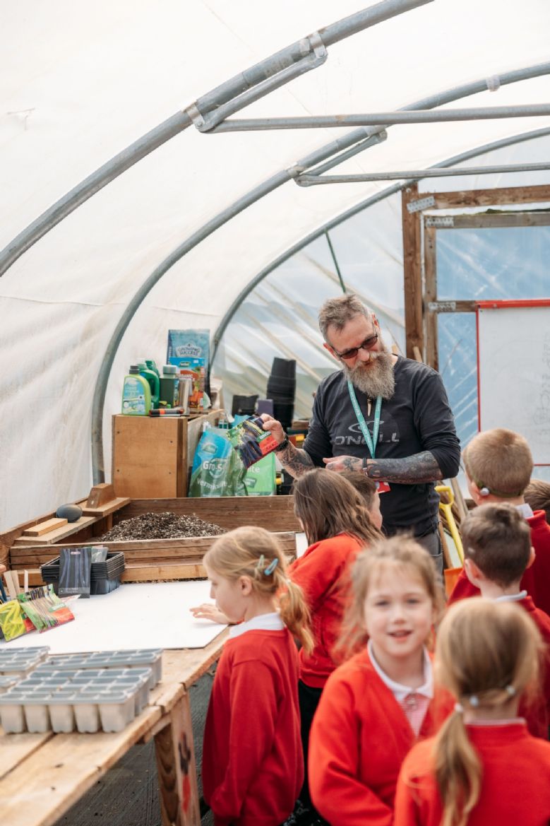children in the polytunnel learning