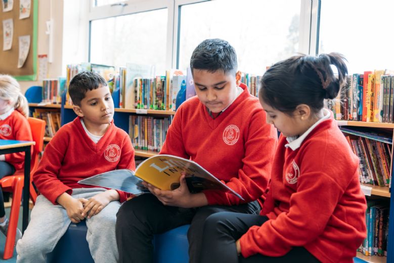 children reading with their peers